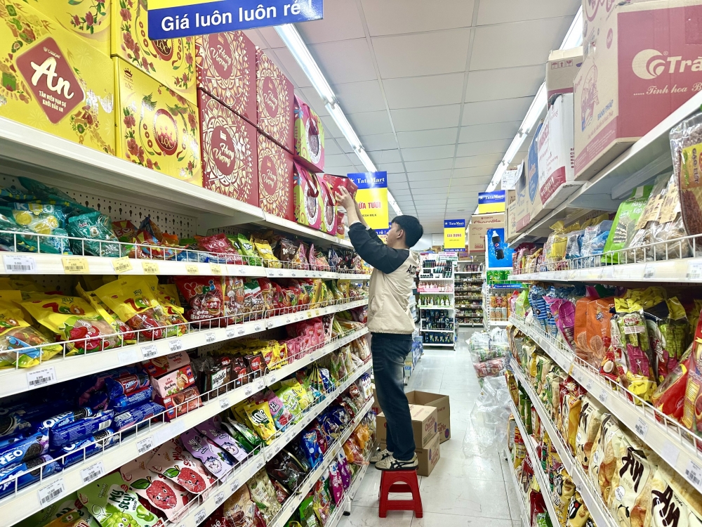 Nhân viên siêu thị xếp hàng hóa lên kệ