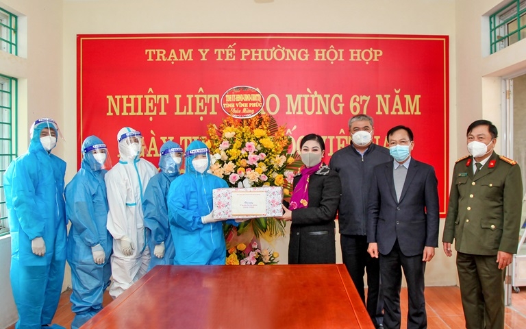 Bí thư Tỉnh ủy Hoàng Thị Thúy Lan tặng hoa chúc mừng các y, bác sỹ Trạm Y tế xã Bình Dương, huyện Vĩnh Tường