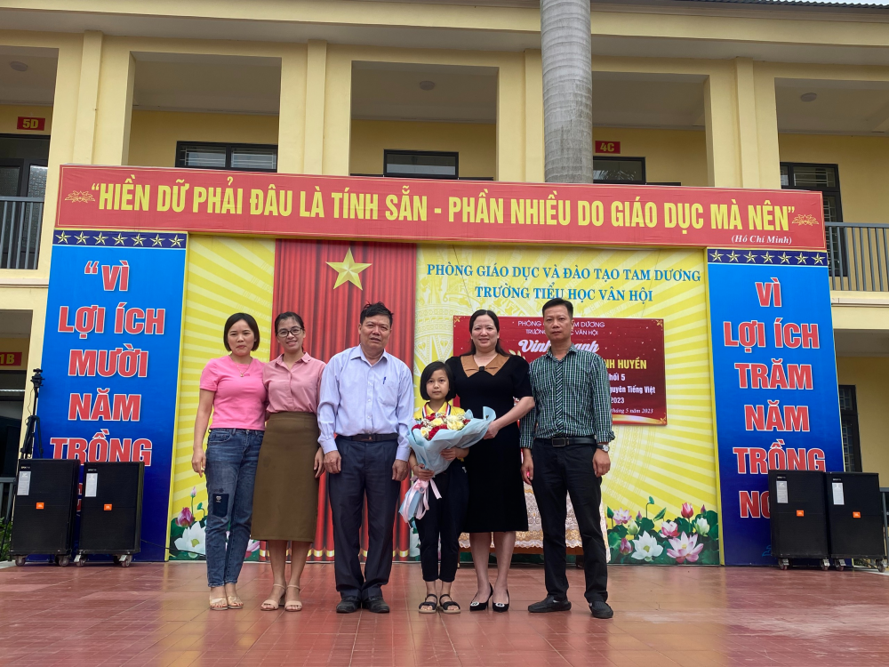 Ông Vũ Việt Dũng – chủ tịch hội Khuyến học huyện Tam Dương tặng hoa chúc mừng em Phan Thanh Huyền và nhà trường