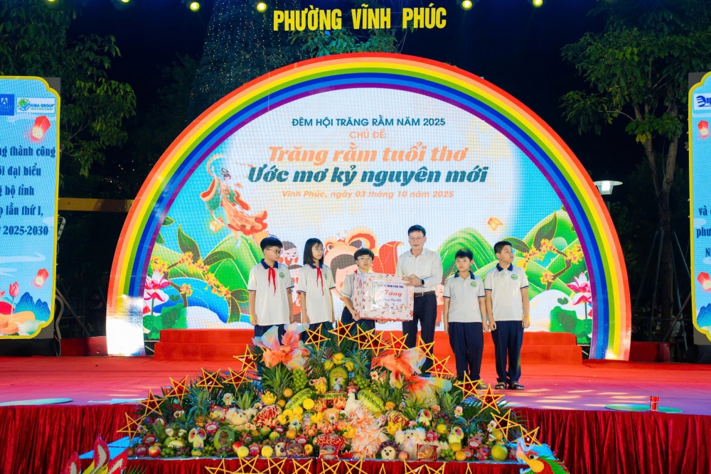 Phó Giám đốc Sở Y tế Nguyễn Ngọc Lợi trao quà cho các em học sinh tiêu biểu khối THCS của phường Vĩnh Phúc.