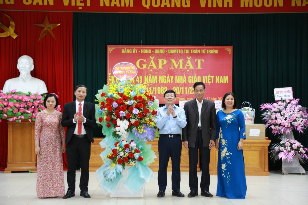 Chủ tịch UBND tỉnh Lê Duy Thành tặng hoa, chúc mừng thầy cô giáo tại thị trấn Tứ Trưng nhân dịp 20/11. 