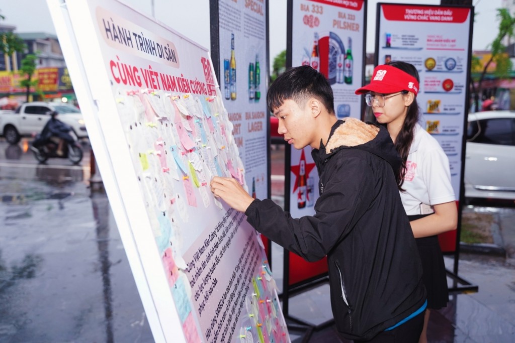 Người dân viết lời nhắn nhủ đến đồng bào bị ảnh hưởng bởi bão lũ tại hoạt động Bức Tường Gắn Kết