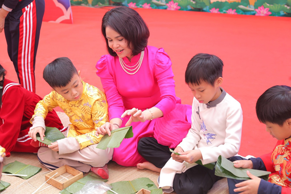 Cô và trò Trường Tiểu học Trung Yên (quận Cầu Giấy) trong lễ hội gói bánh chưng.