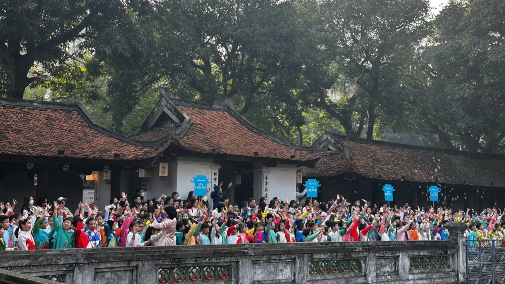 Khách Tây thích thú với hình ảnh học sinh mặc áo dài, đồng diễn tại Văn Miếu – Quốc Tử Giám