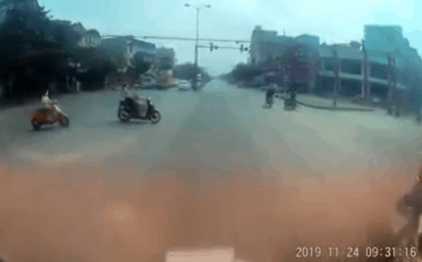 Cô gái đi xe máy bất ngờ ngã trước mũi ô tô