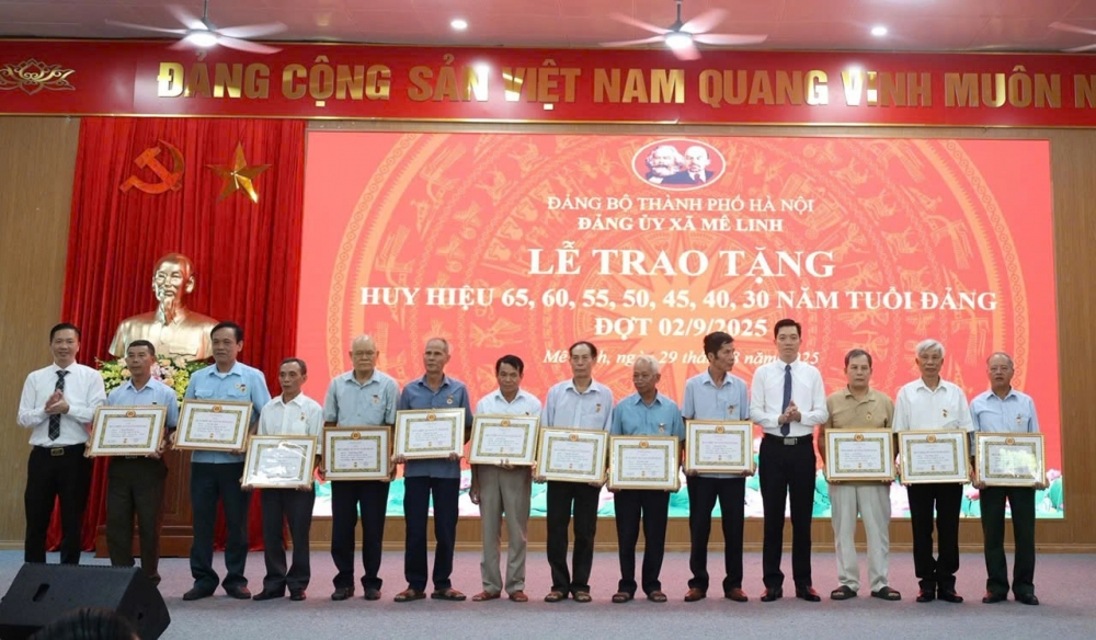 Đồng chí Nguyễn Ngọc Liêm - UVTV, Trưởng ban Xây dựng Đảng trao Huy hiệu 45 năm tuổi Đảng tặng các đảng viên.