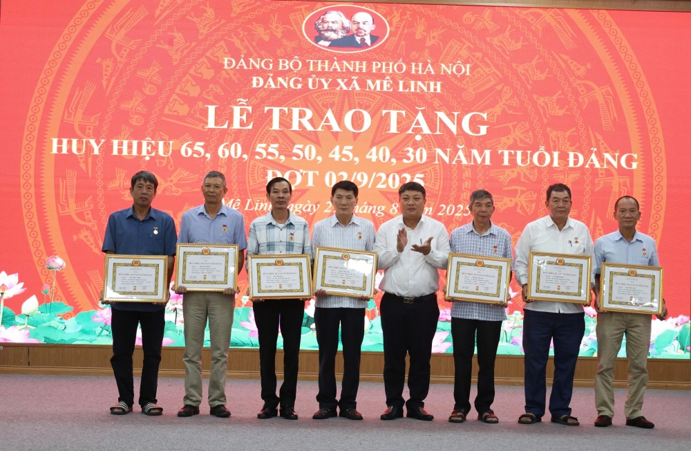 Đồng chí Trần Sỹ Đạt - Ủy viên BTV, Phó chủ tịch UBND xã trao Huy hiệu 40 năm tuổi Đảng tặng các đảng viên.